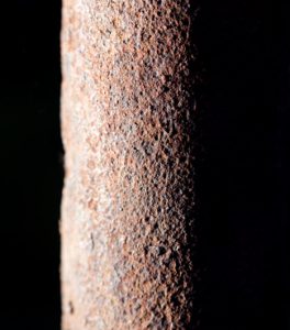 rusty pipe on black